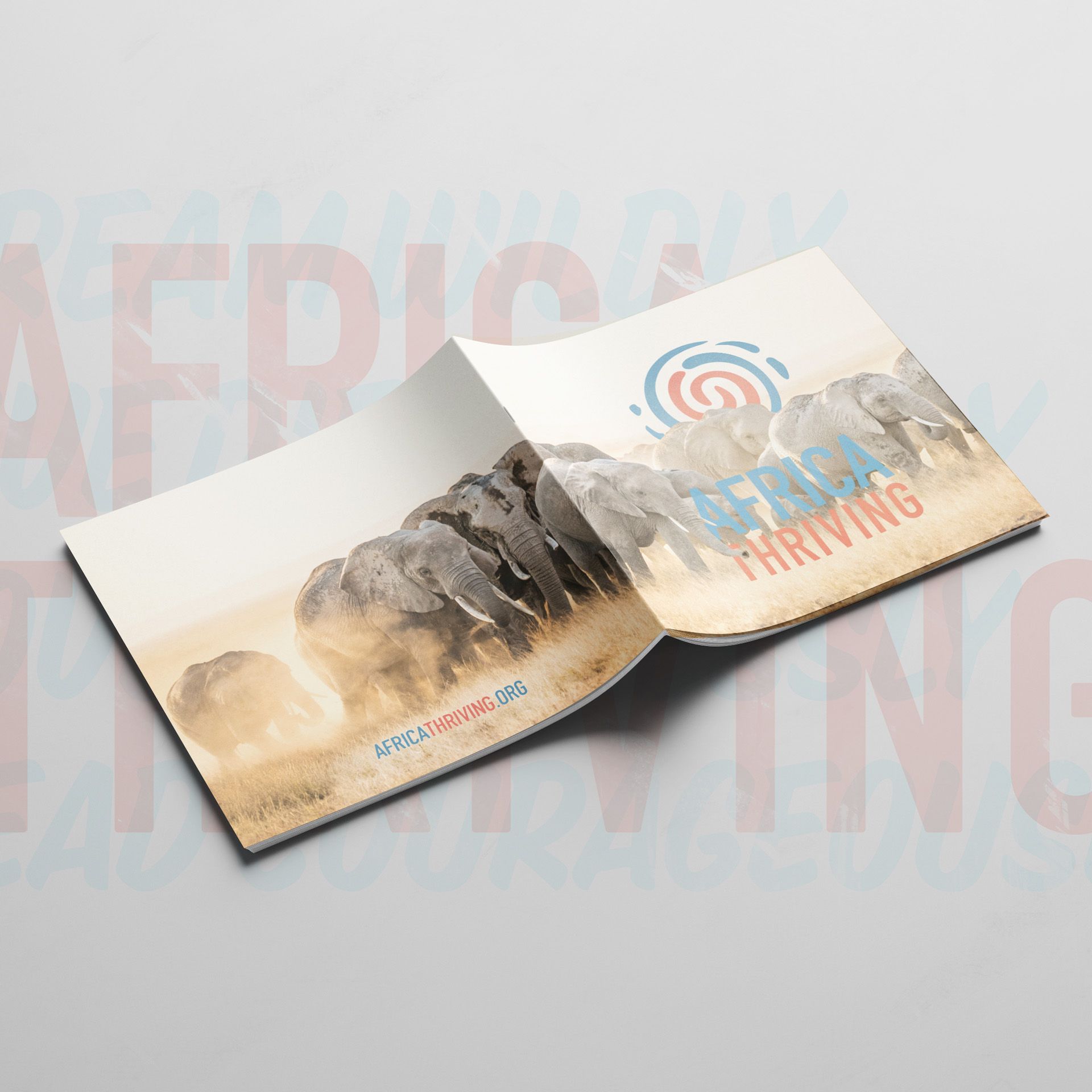A book is open to a page with a picture of elephants on it.