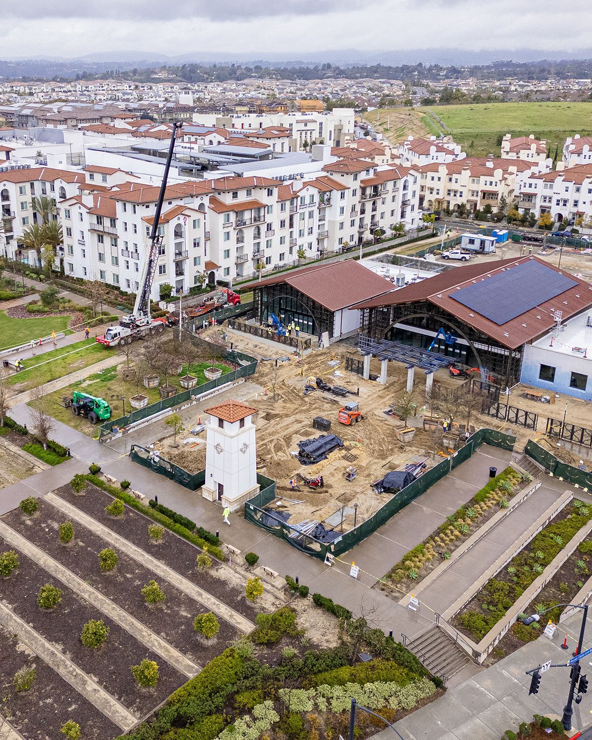 An aerial view of a building under construction in a city.