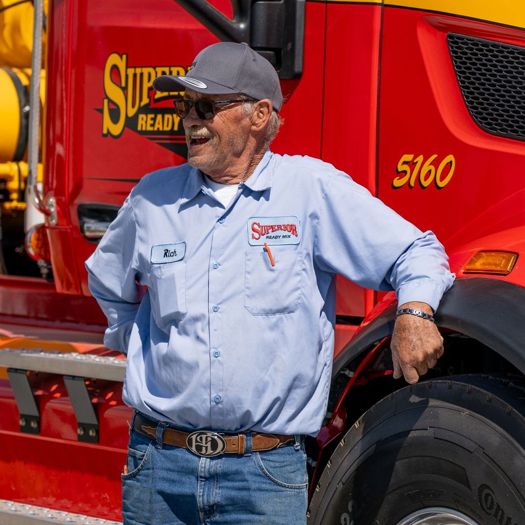 A man standing in front of a red super ready truck