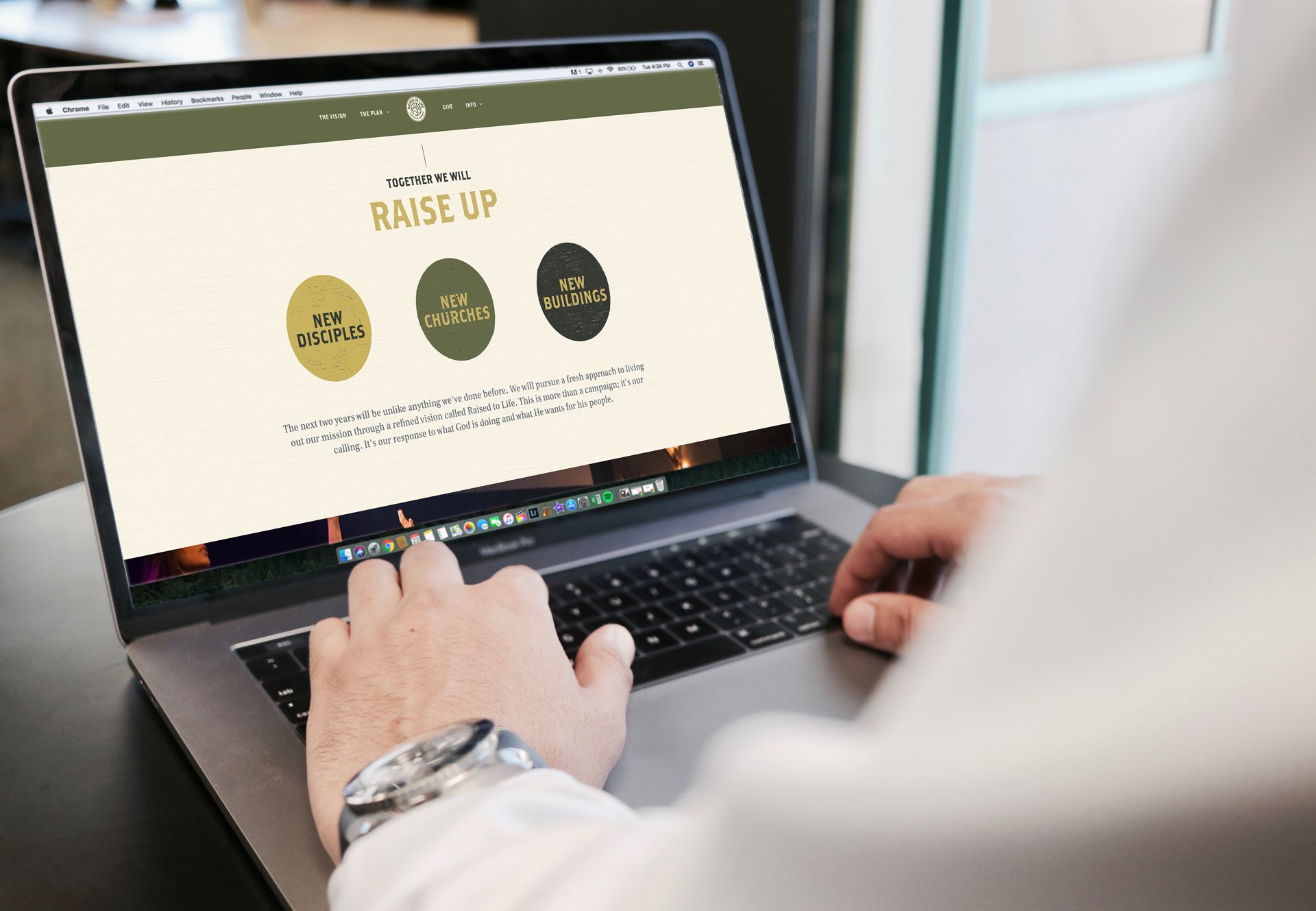 A person is typing on a laptop computer that says raise up on the screen.