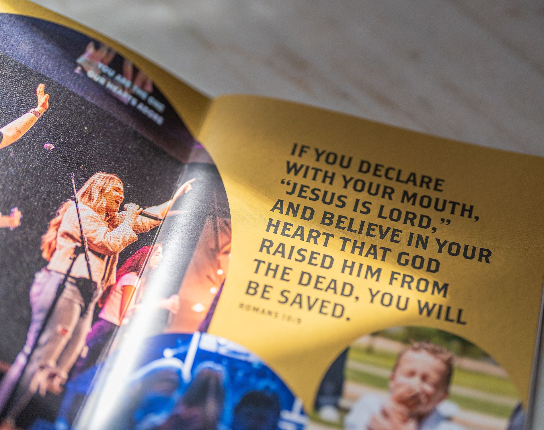 A book is open to a page that says if you declare with your mouth jesus is lord