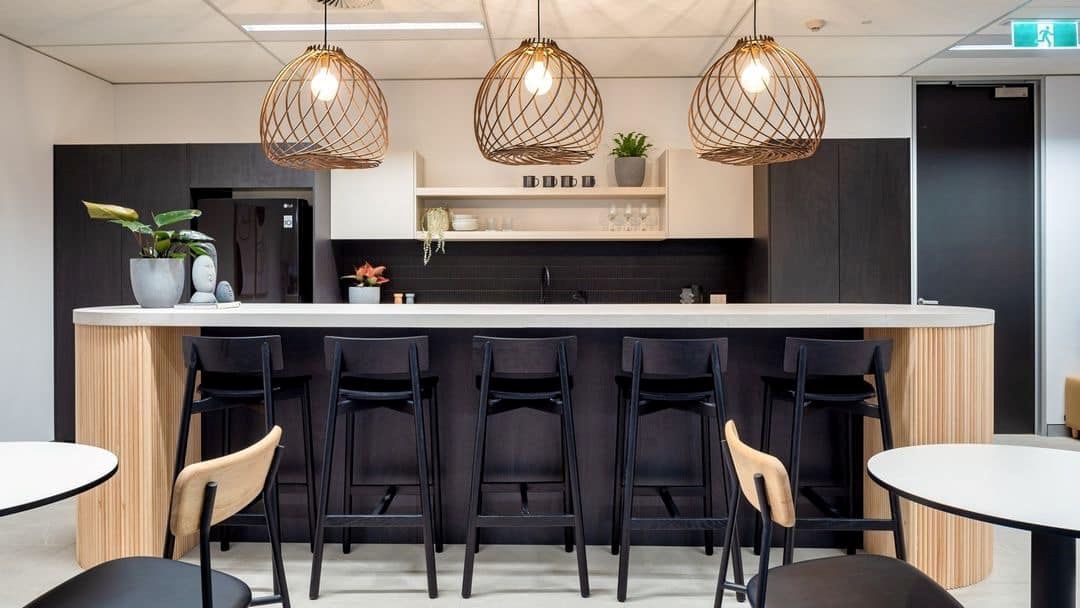 A Kitchen With a Long Counter and Stools and Tables — Concept Kitchens In Port Macquarie, NSW
