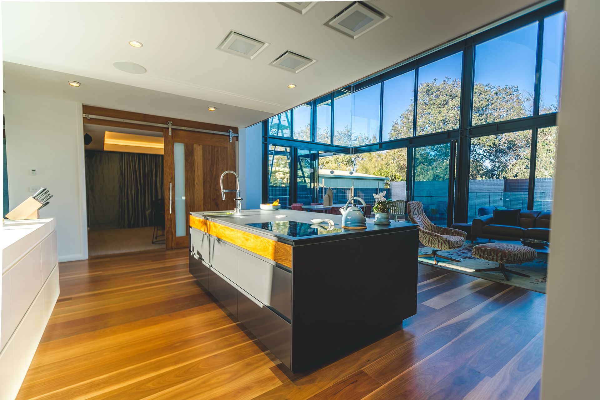 A Long White Cabinet With Wooden Shelves and Drawers in a Room — Concept Kitchens In Wauchope, NSW