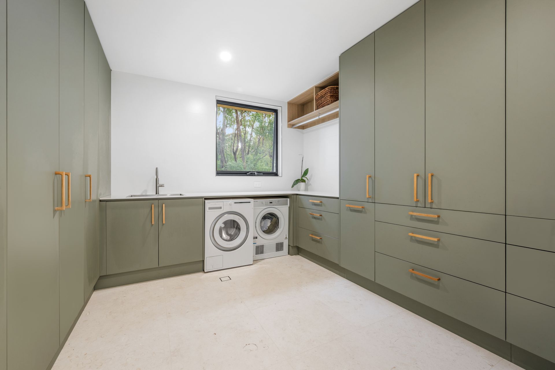 A laundry with a sink, washer and dryer. — Concept Kitchens In Port Macquarie, NSW