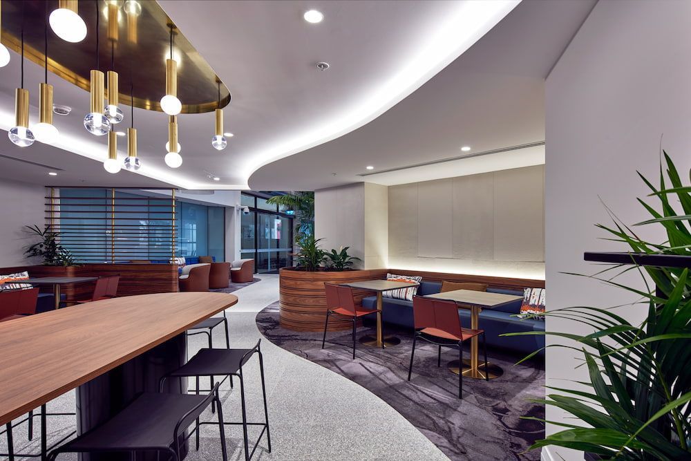 A Room With Tables and Chairs and a Chandelier Hanging From the Ceiling — Concept Kitchens In Port Macquarie, NSW
