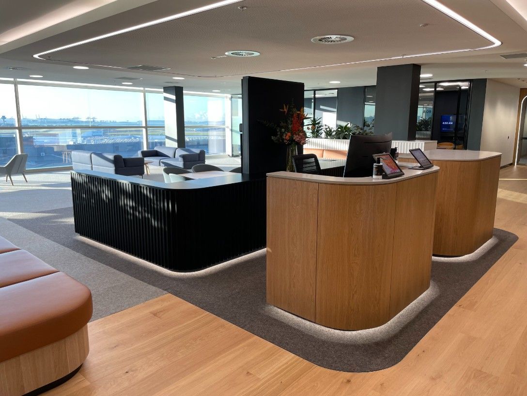 A Reception Area With Two Wooden Tables And A Bar — Concept Kitchens In Port Macquarie, NSW