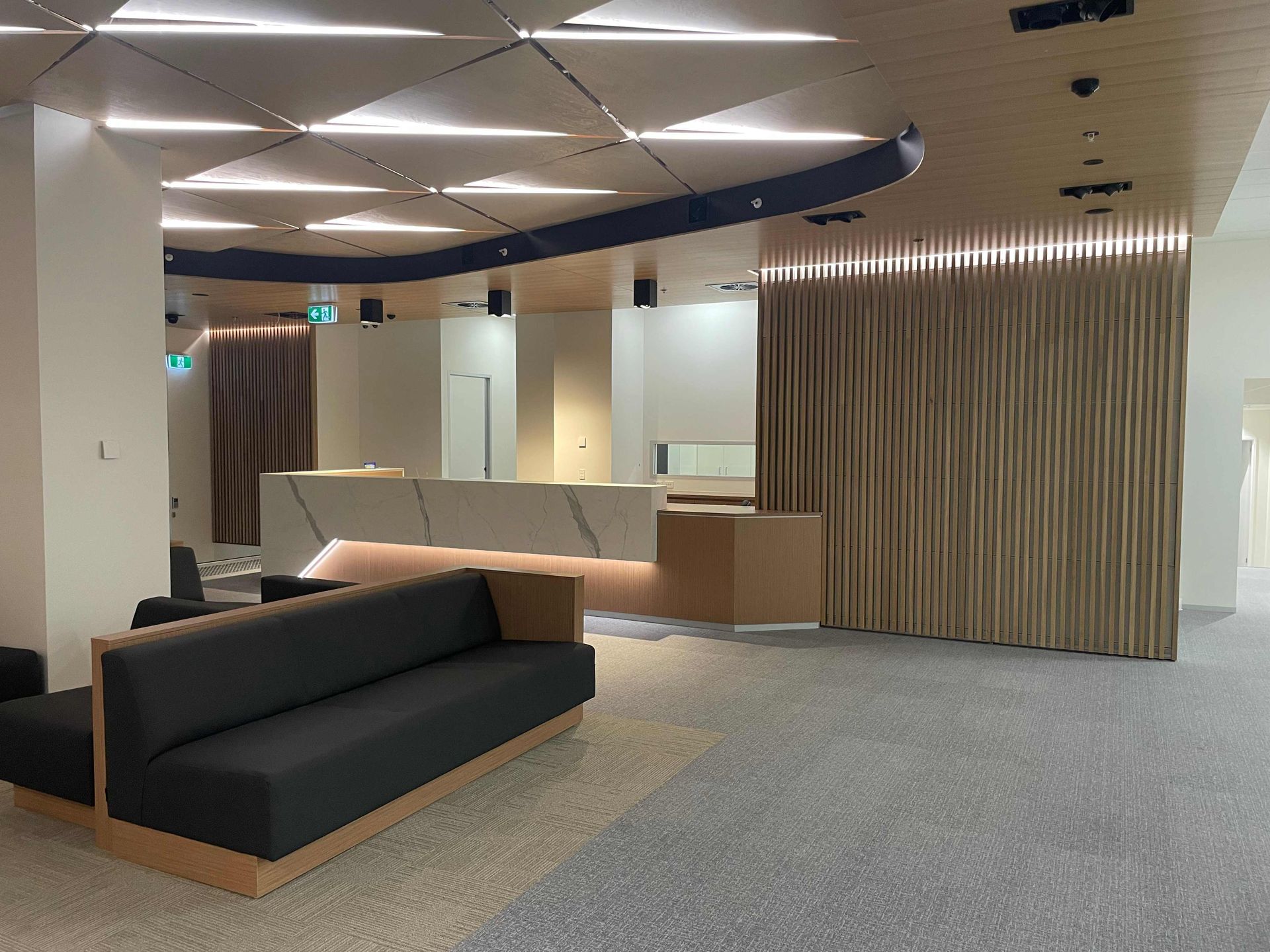 There Is A Dark Brown Couch In The Middle Of The Well-Lit Room — Concept Kitchens In Port Macquarie, NSW