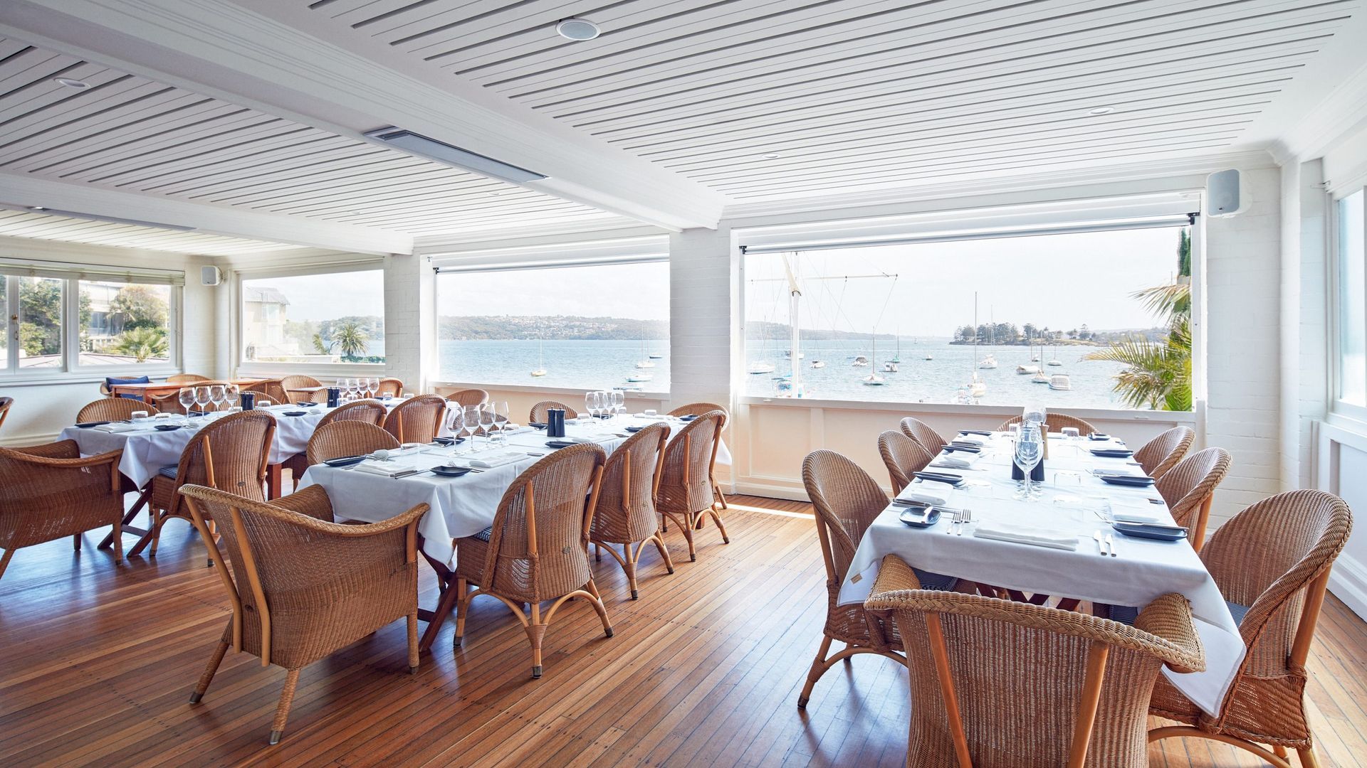 A Large Well-Lit Dining Room With Tables And Chairs And A View Of The Ocean — Concept Kitchens In Port Macquarie, NSW
