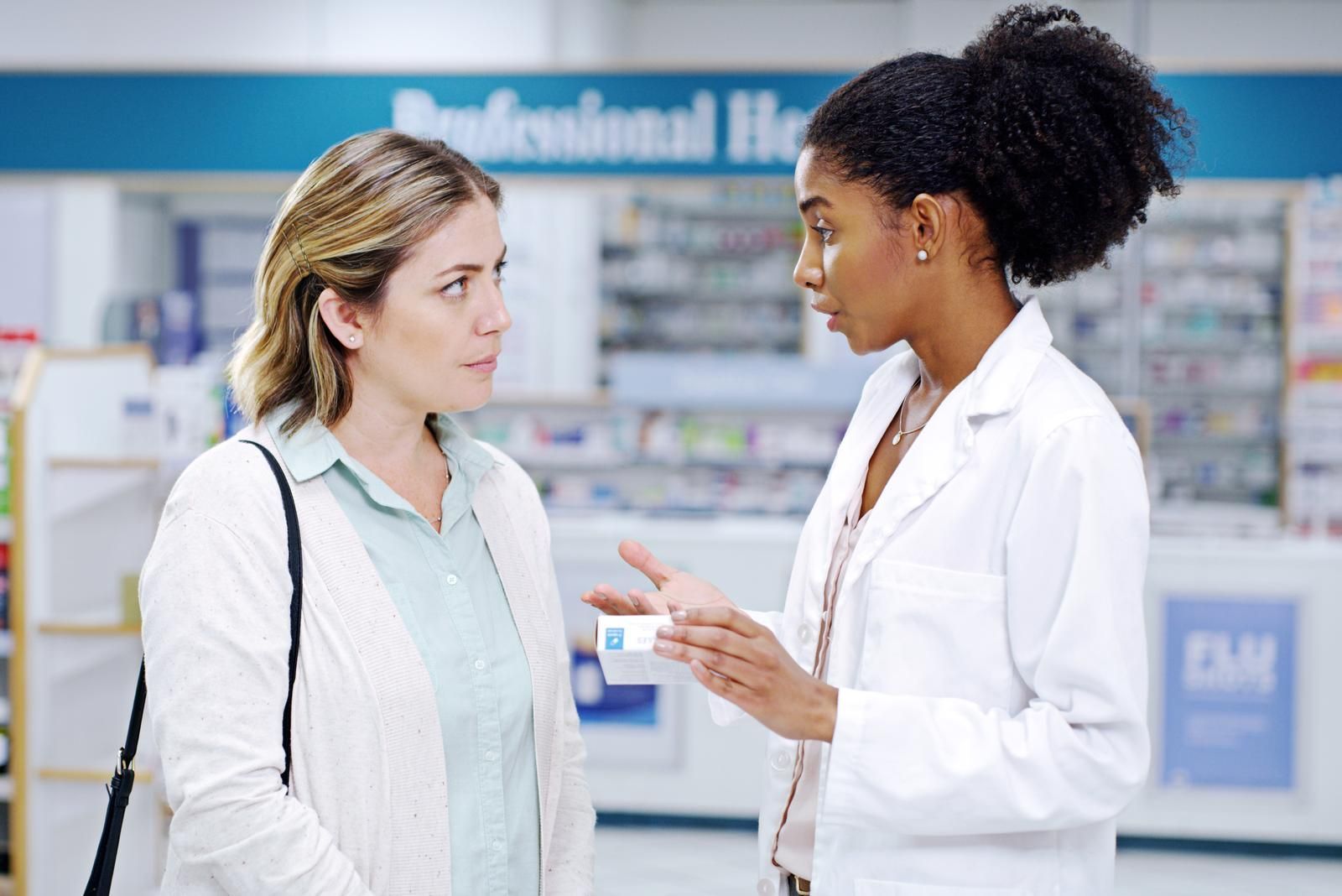 Pharmacist consulting with a patient about a prescription refill