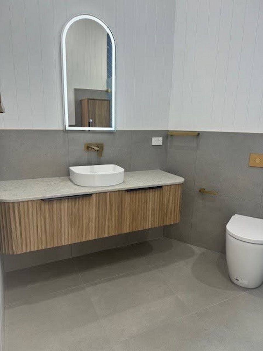 Modern Bathroom With Floating Wood Vanity, Round Sink and Mirror — Mid Coast Tile Co in Forster, NSW