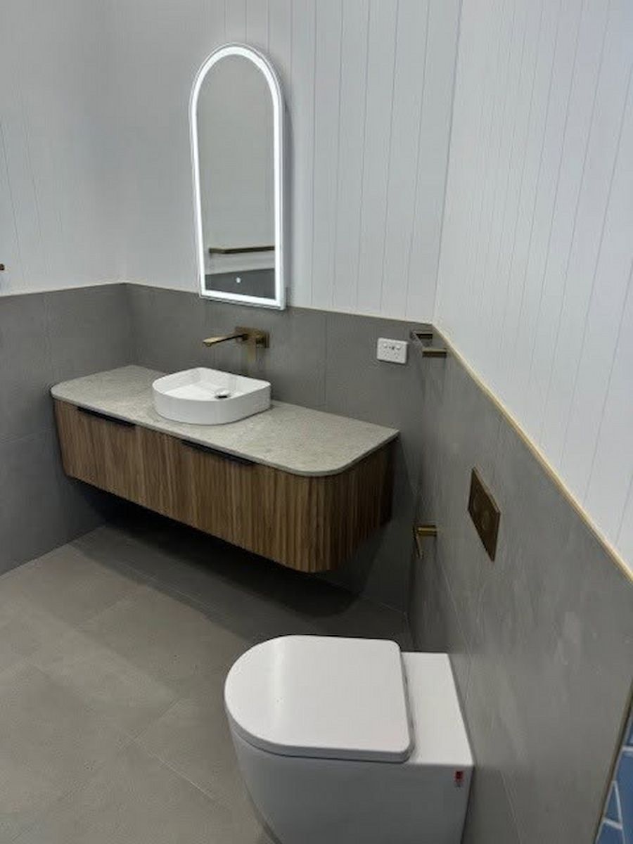 Accessible Bathroom With Toilet, Sink, Mirror, and Gray Walls and Floor — Mid Coast Tile Co in Forster, NSW