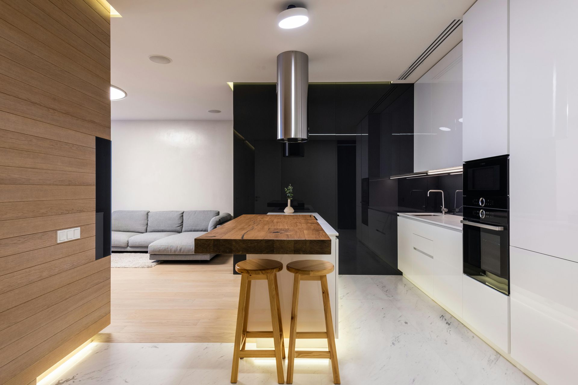 Modern Open-Plan Kitchen with Wooden Island, White Cabinetry, Black Accents — Mid Coast Tile Co in Taree, NSW