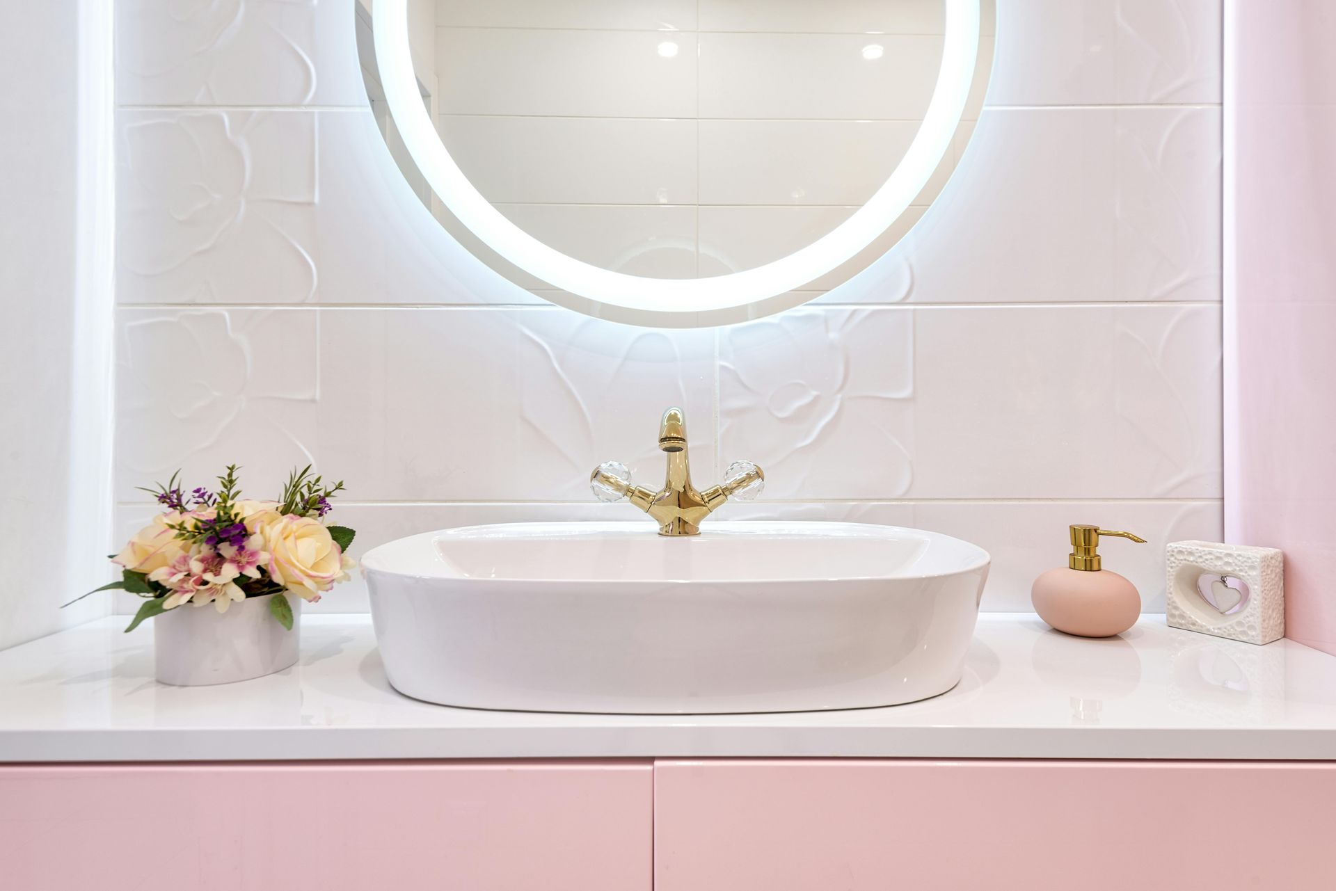Modern Pink Bathroom Vanity with Round Backlit Mirror, White Sink, Flowers — Mid Coast Tile Co in Taree, NSW