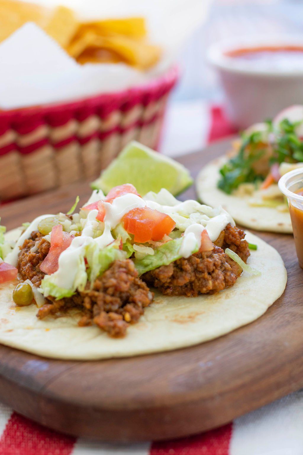 A close up of a taco on a wooden cutting board.