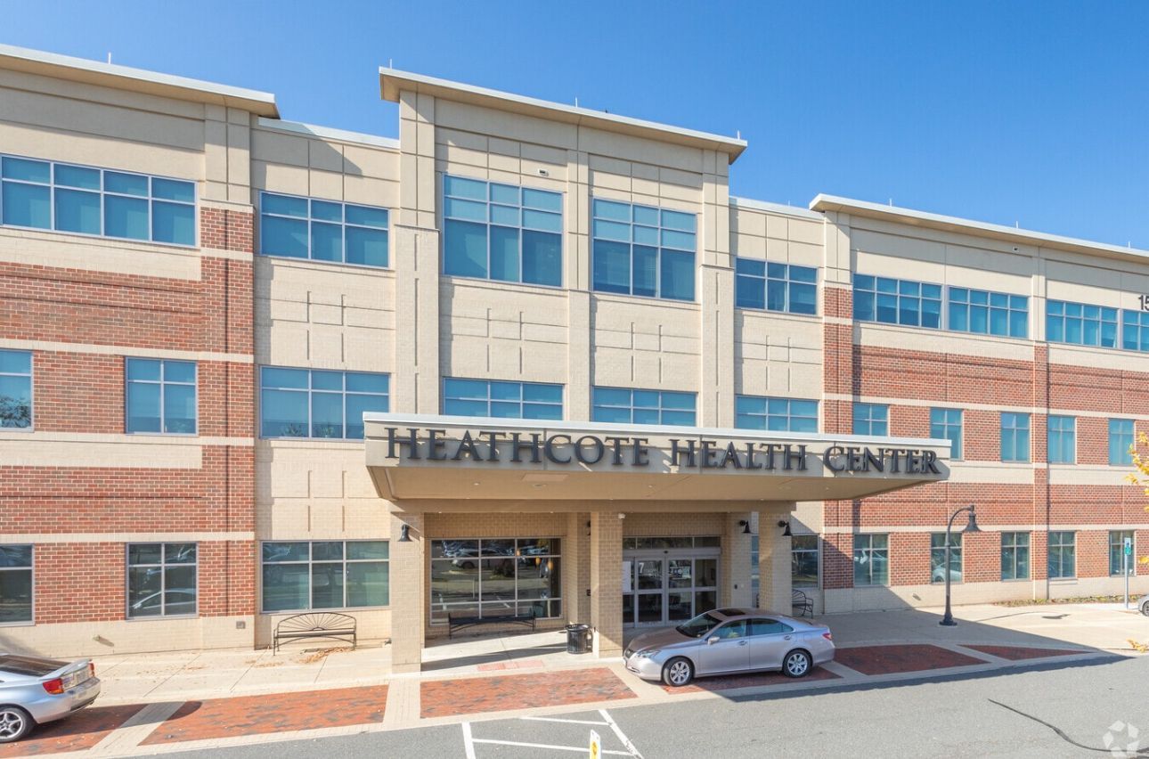 Heathcote Health Center building exterior with brick and tan facade, sunny day.