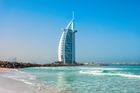 Burj Al Arab hotel on a sunny beach with turquoise water and a clear blue sky
