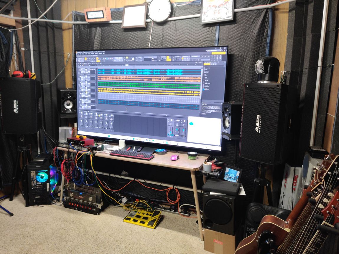Front of room: Alesis Speakers, Studio Monitors, Cakewalk Sonar Screen, Equalizers, Amplifiers, Guitar Stomp Box and other equipment.