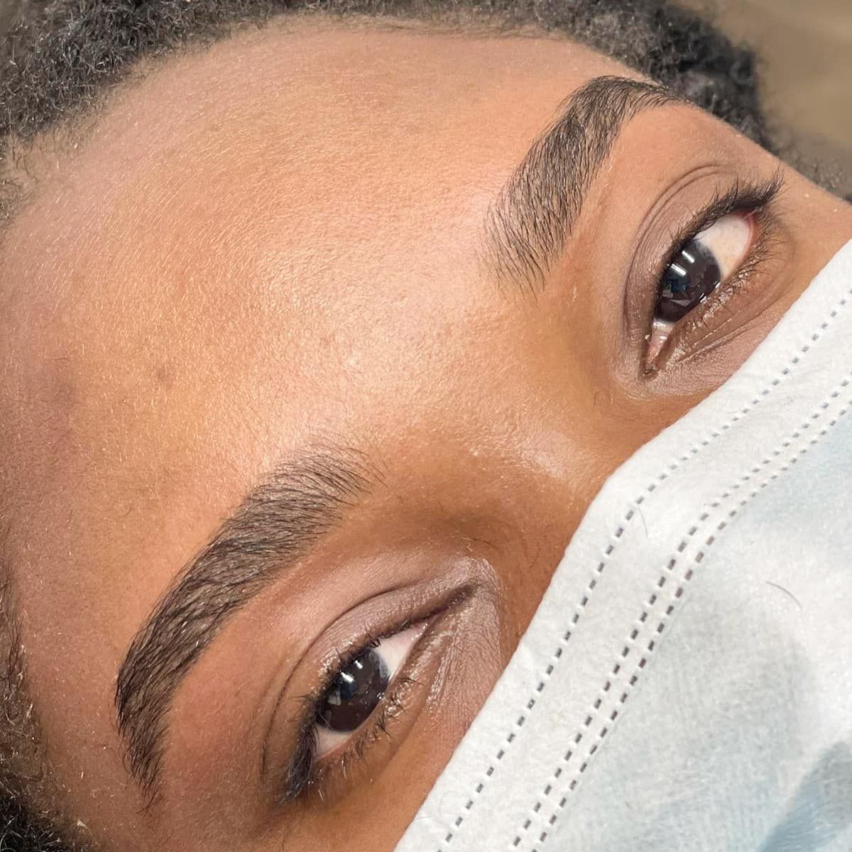A close up of a woman 's face with a mask on.