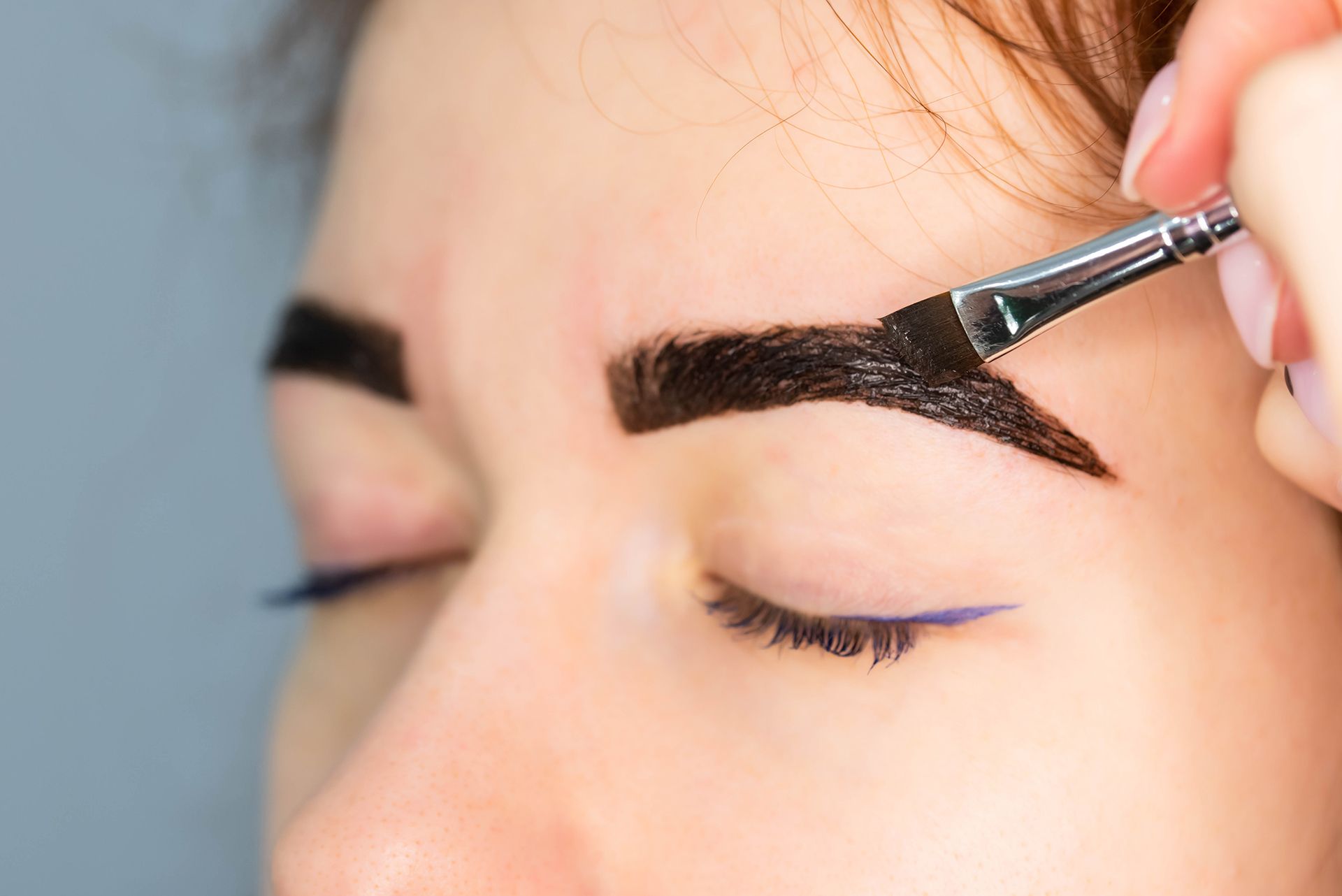 Applying Tint to Her Eyebrows