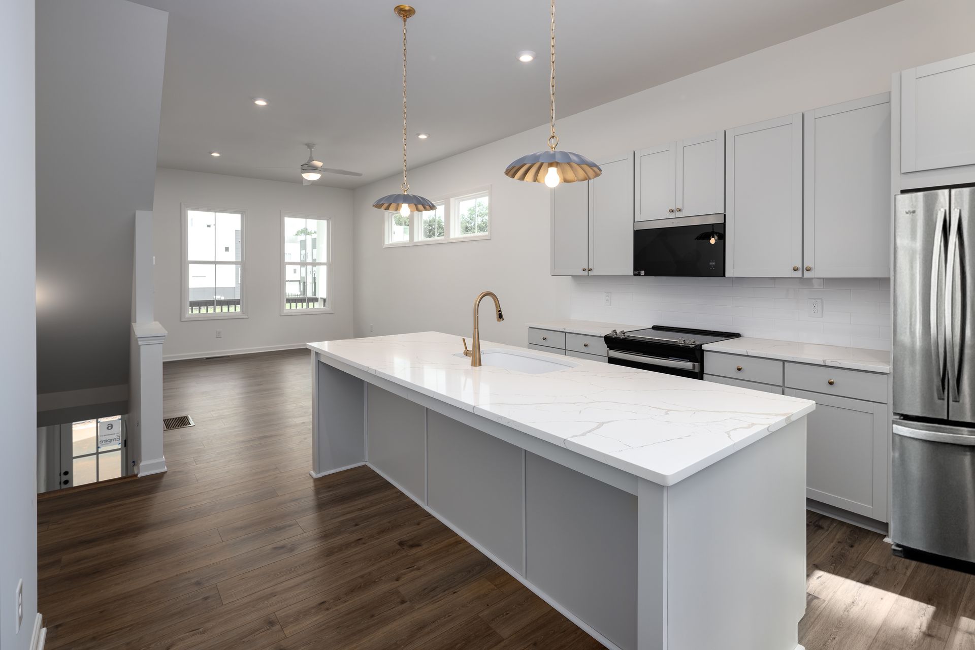 Songbird Apartments Kitchen Island with Gold features
