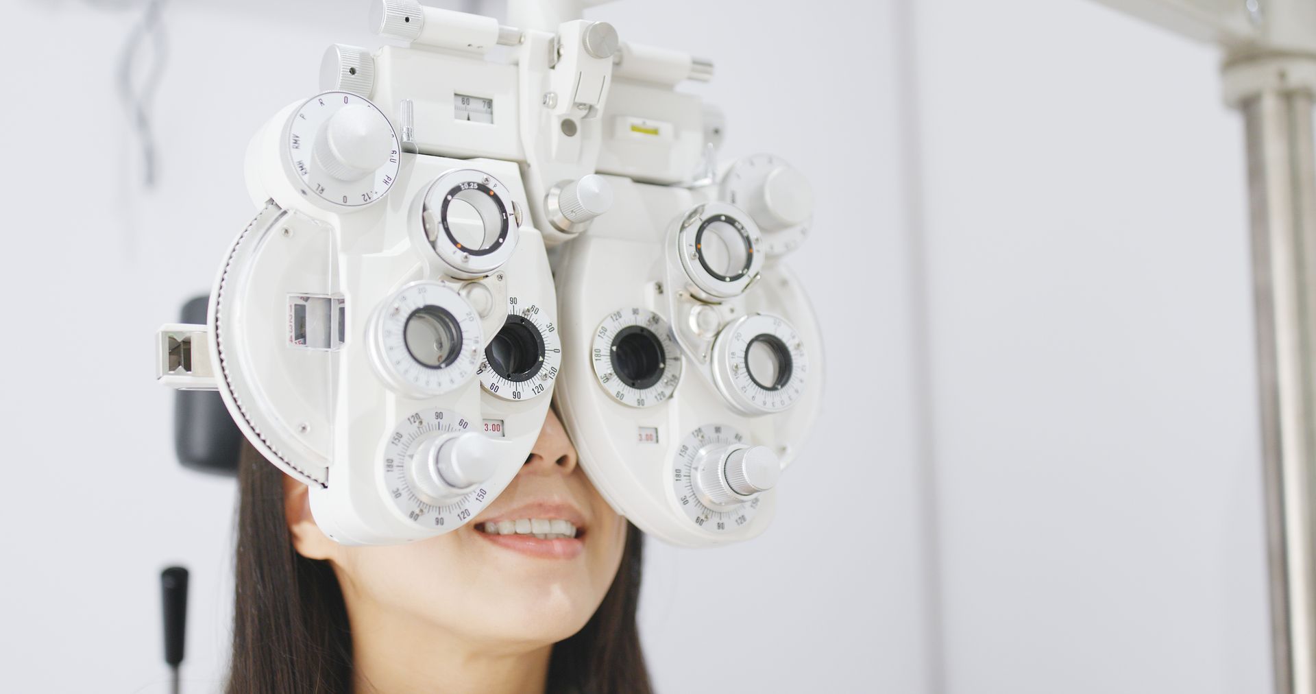 Eye exam using an optical phoropter to check vision.
