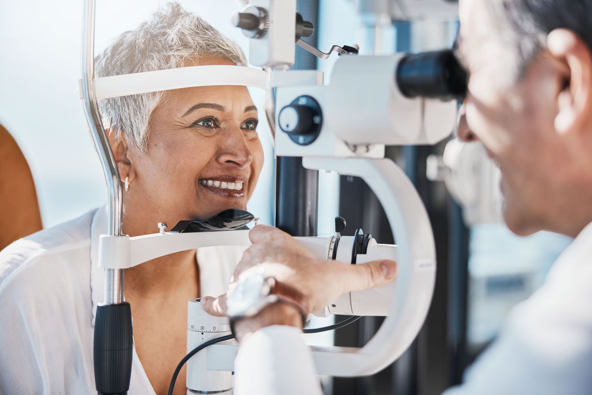 Eye specialist conducting a slit lamp examination during a routine eye checkup. Eye specialist conducting a slit lamp examination during a routine eye checkup.