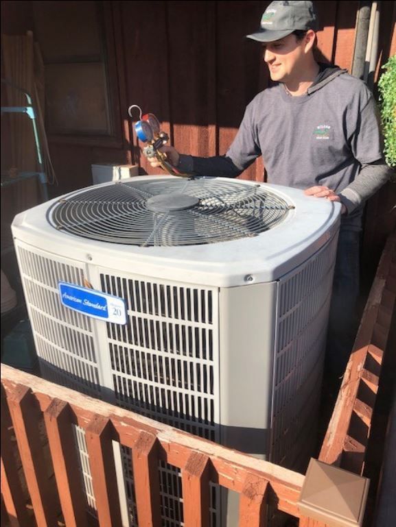 A Man Working on the Air Conditioner - Lindsay, OK - Wilson Air Conditioning & Heating