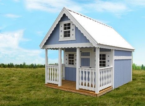 Small blue and white playhouse with a porch on grass under a clear sky