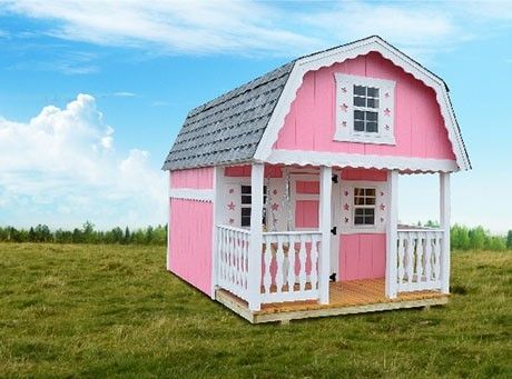 Pink playhouse with white trim and porch in a grassy field under a blue sky