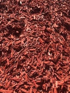 Pile of red-brown wood chips filling the frame