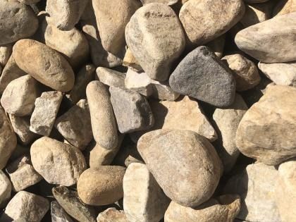 Close-up of beige and gray gravel stones filling the frame
