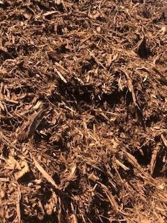 Close-up of brown wood chips and mulch covering the ground