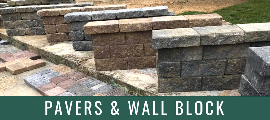 Stacked stone pavers and retaining wall blocks in tan, gray, and brown colors.