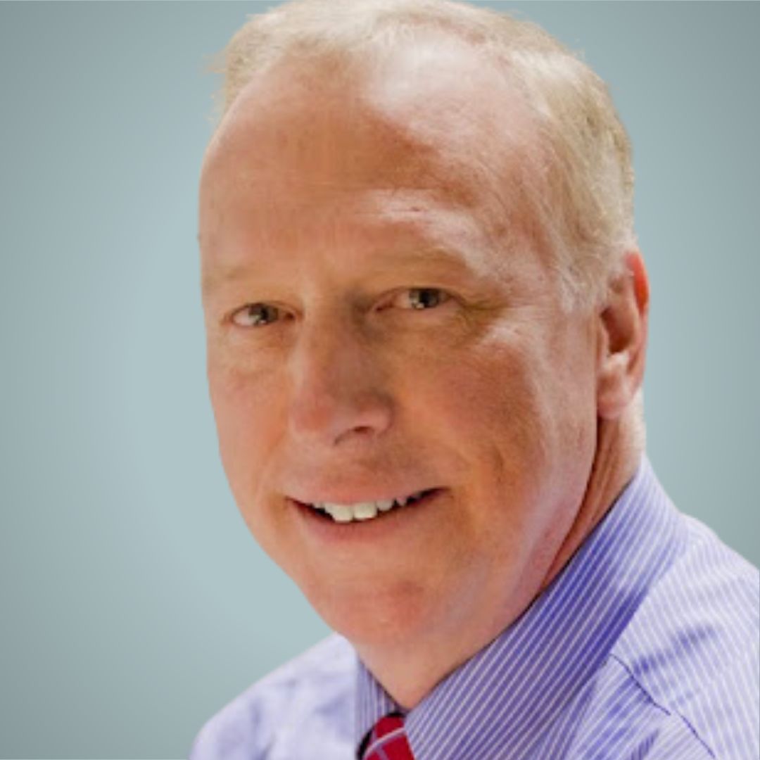 A man in a striped shirt and tie smiles for the camera