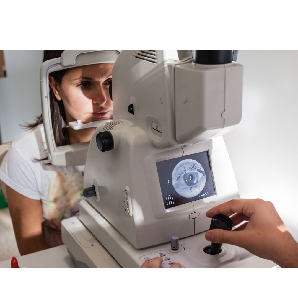 A woman is getting her eyes examined by an ophthalmologist