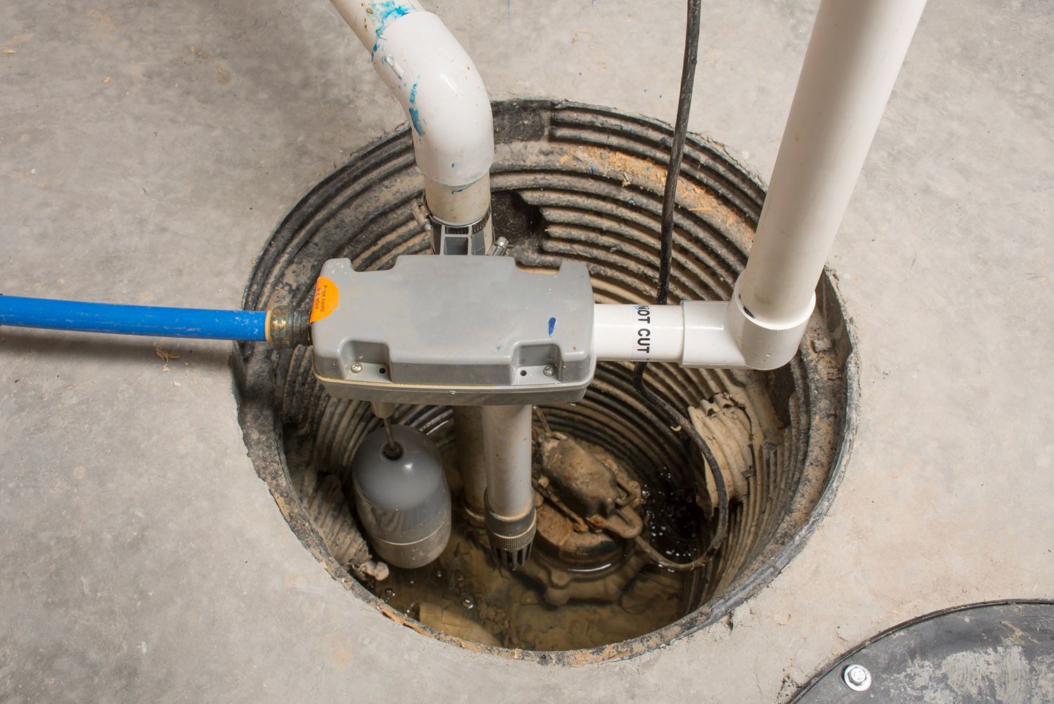 A close up of a sump pump in a basement. A close up of a sump pump in a basement.