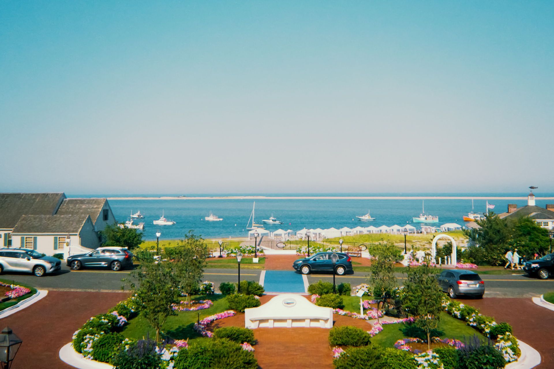 City skyline across a body of water under a blue sky with scattered clouds