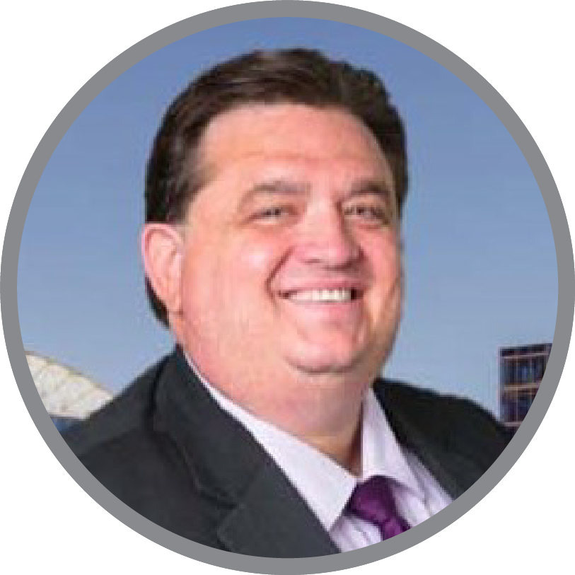 A man in a suit and tie is smiling in a circle. used as an image of the client who left the testimonial on our website.