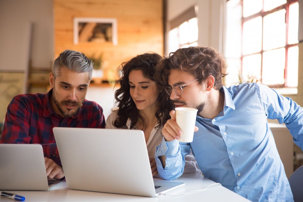 two men and a woman thinking of how to help by Driving Traffic to Your Company Website