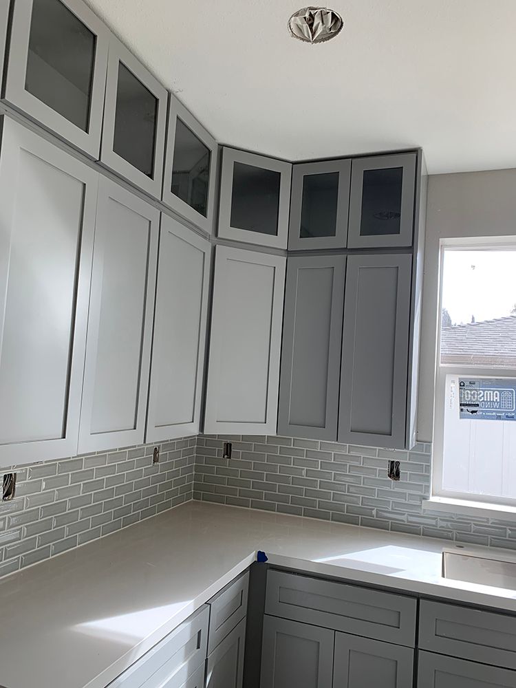 Kitchen corner with tall cabinets above countertops
