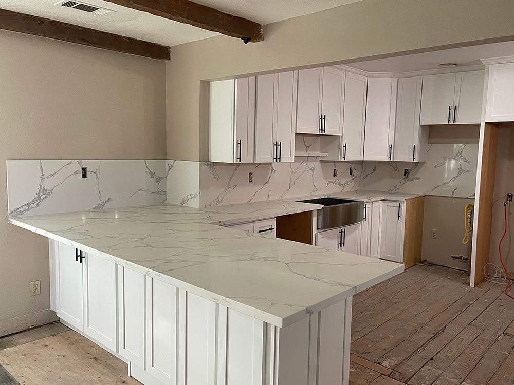 White marble counters and kitchen cabinet installation