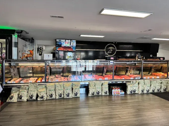 Bakery display case with assorted pastries, menu screens, and dog-patterned decor in a modern cafe