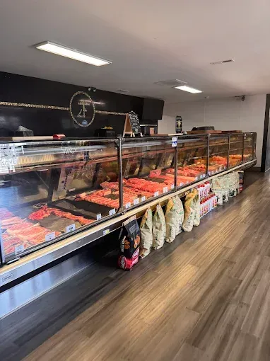 Bakery display cases filled with pastries and breads along a wood-floored shop interior