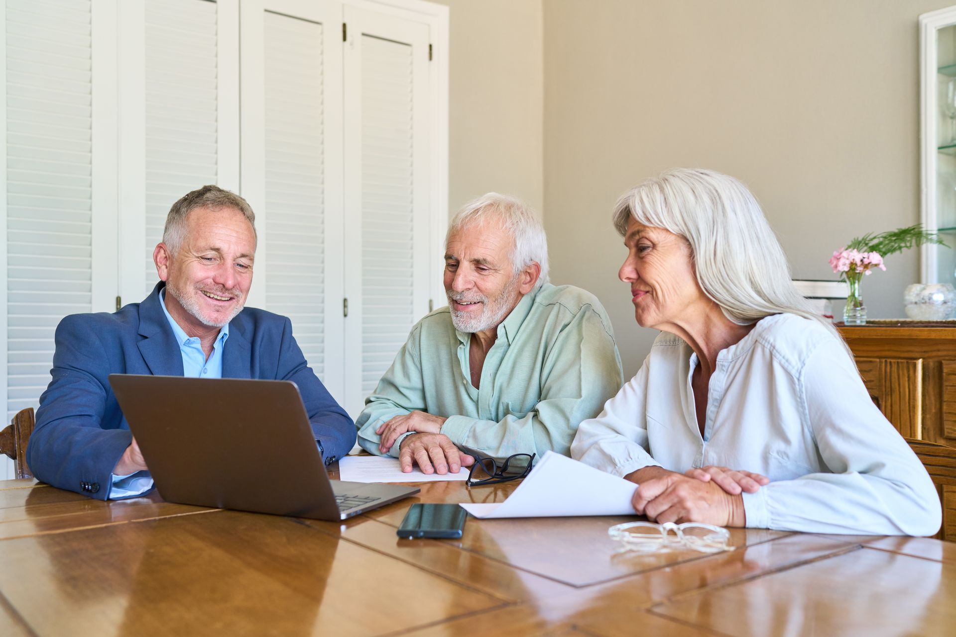 Estate planning attorney meeting with an older couple to review documents.