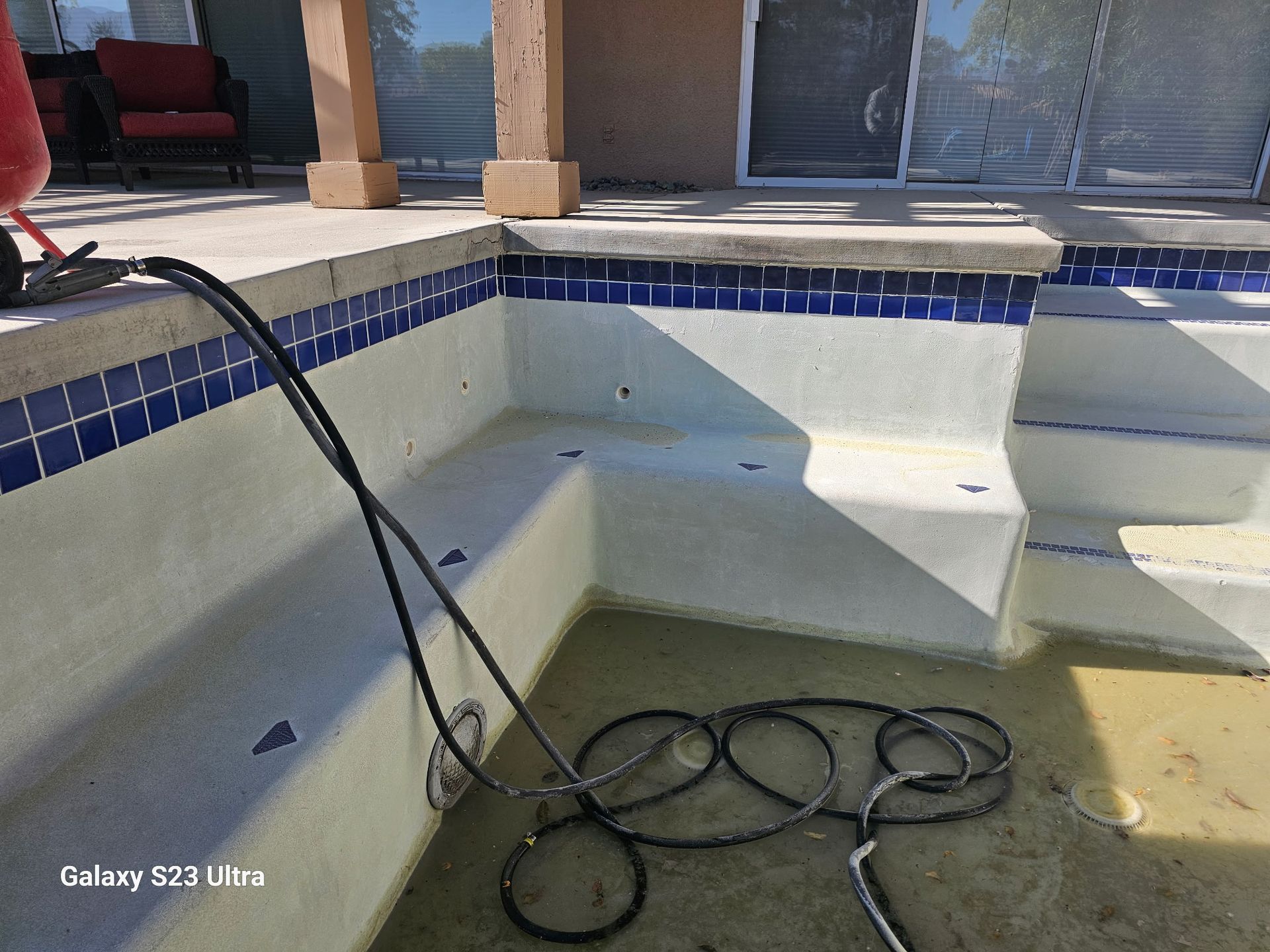 A galaxy s23 ultra is being used to take a picture of a swimming pool.