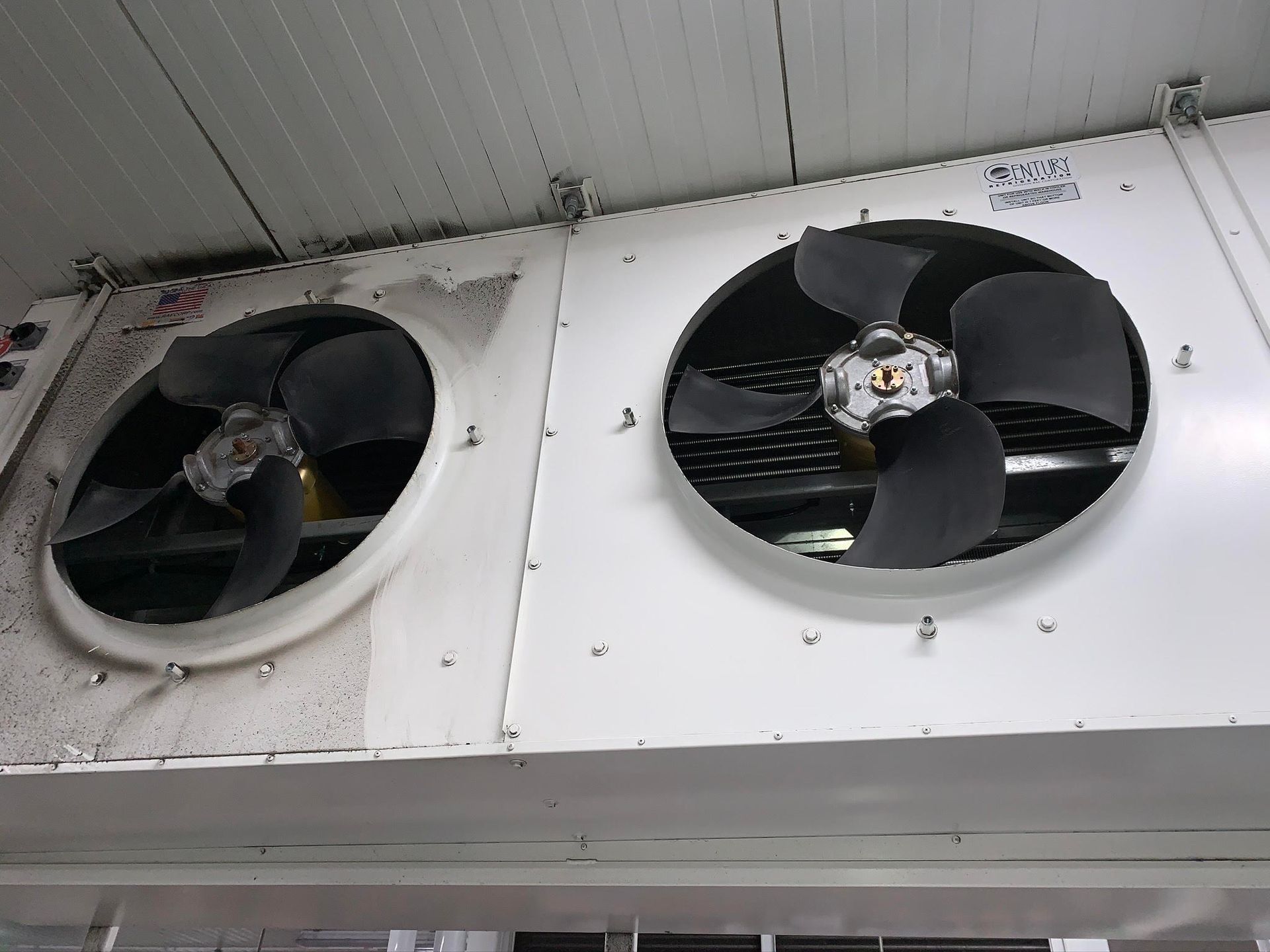 A woman is using a remote control to turn on an air conditioner installed by Pro Temp.