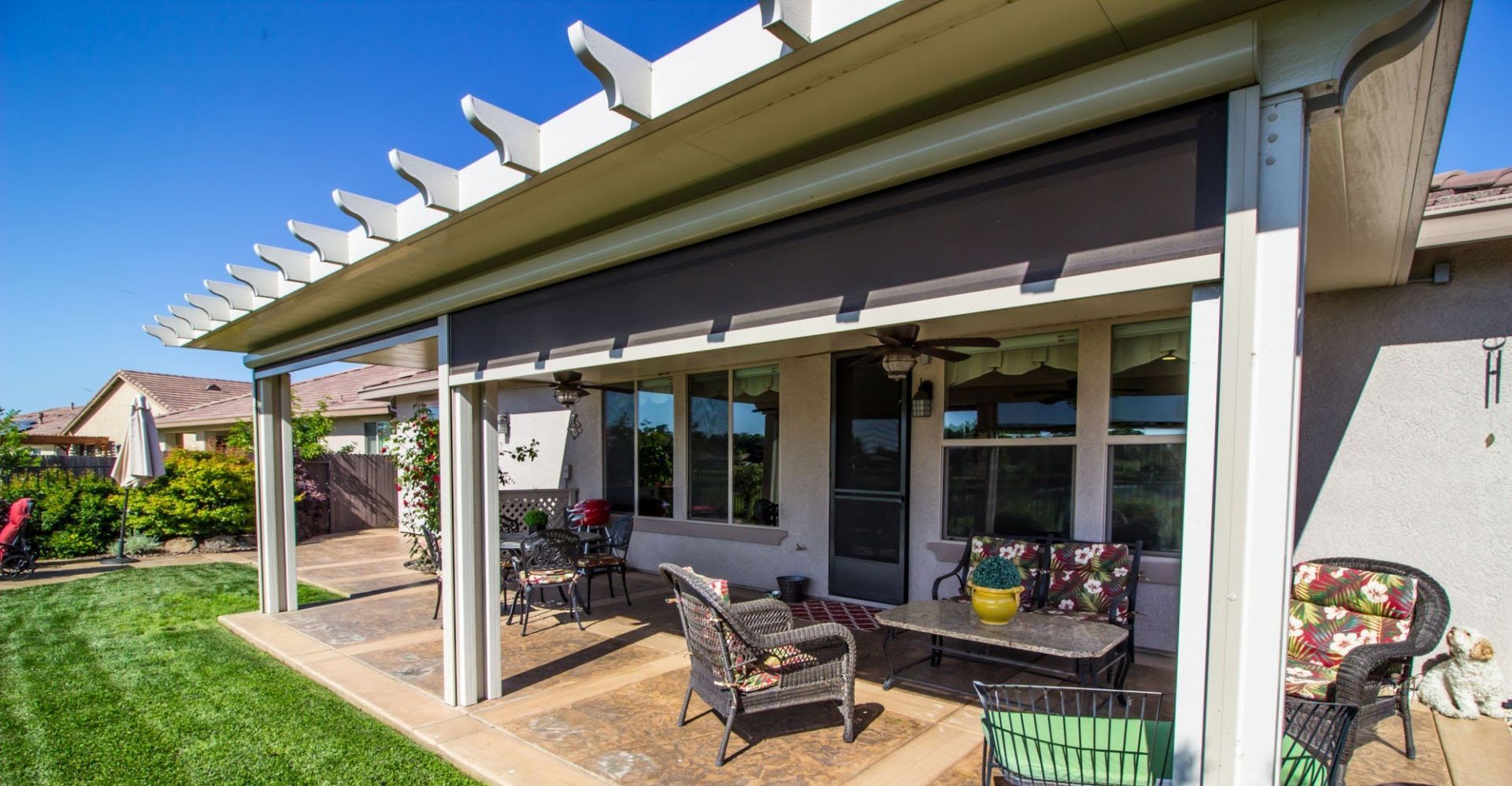 Patio cover in Boerne backyard with ceiling fans & lights