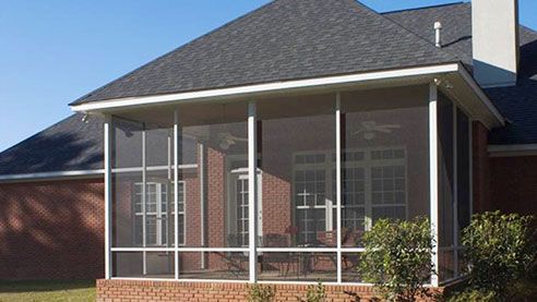 Round Rock screen room added to a two‑story home, using full‑height screen walls to maximize airflow and visibility.