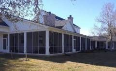 Seguin screen room featuring a bright insulated roof and clean framing lines for a simple, functional outdoor space.