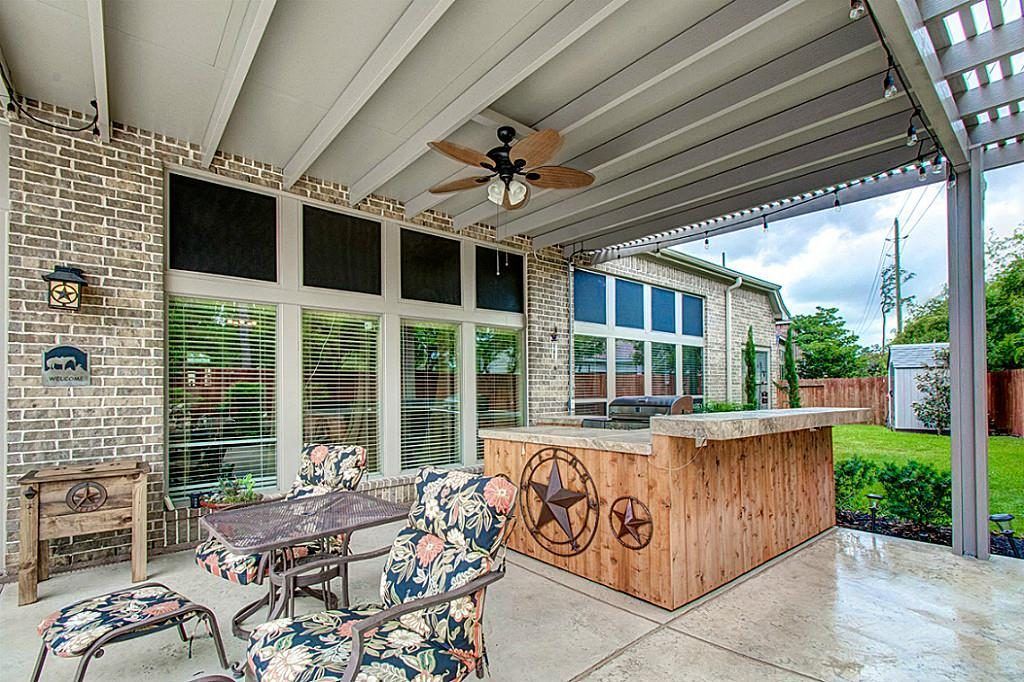 Patio cover with dual-level roof design and skylights in Zorn, TX